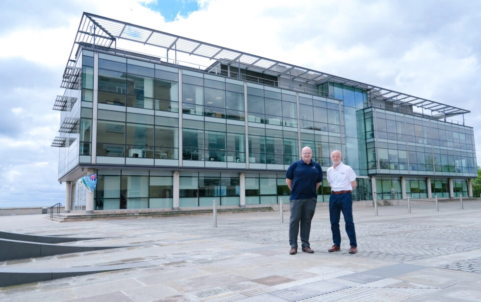 Chris Grsvenor and Tolis Chatzisymeon stood out front of the Spencer Group, wide shot